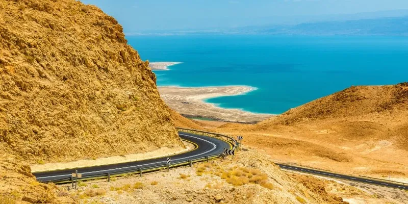 The scenic view of the Dead Sea Highway with mountains in the
background