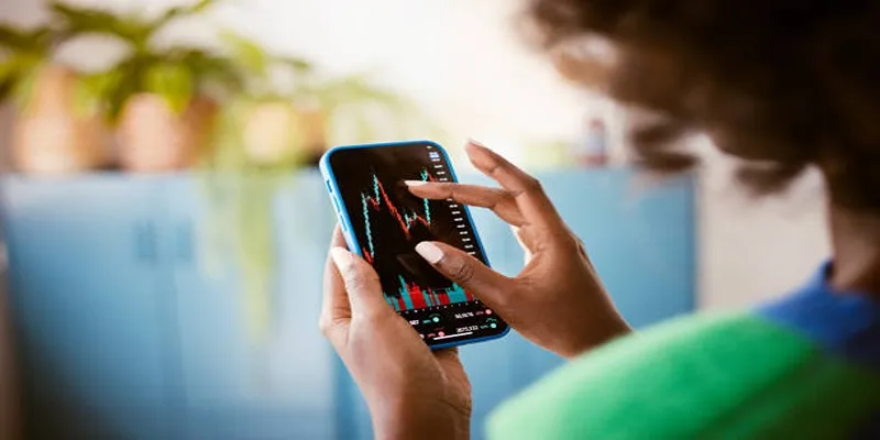 A person reading financial books to learn about the stock market